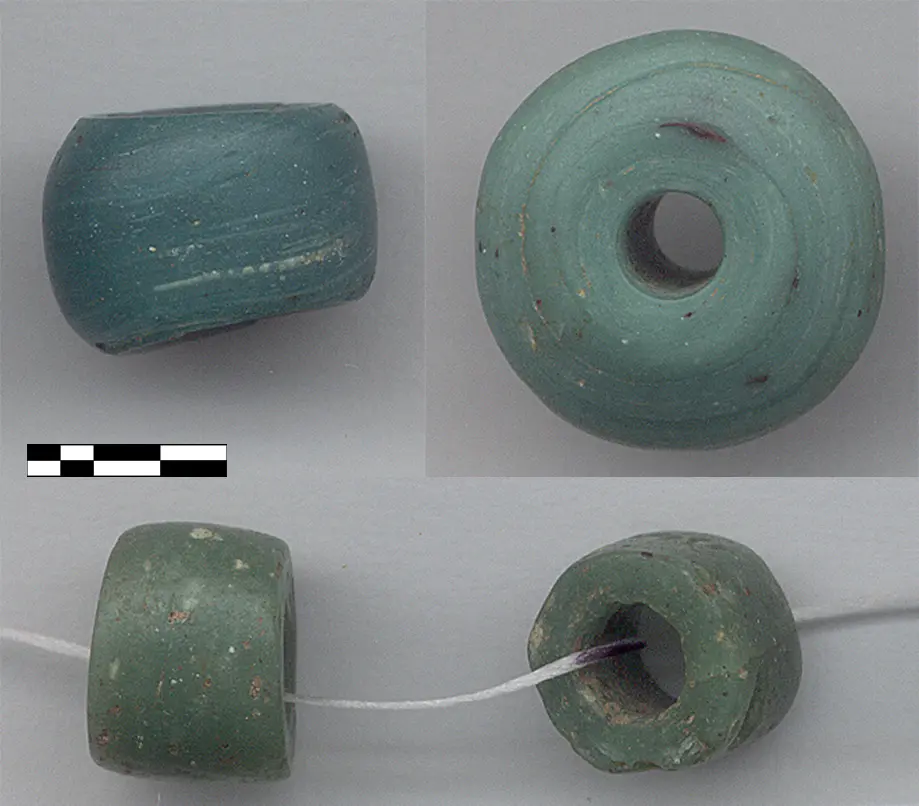 Green glass trade beads excavated at Ing’ombe Ilede, shown with a scale bar