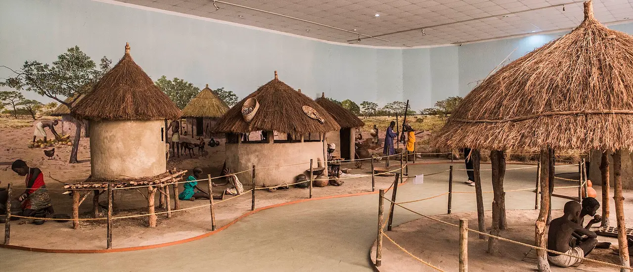 Village life display with thatched huts and granaries inside the National Museum in Lusaka