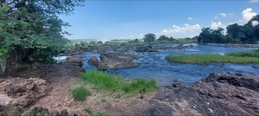 Rocky riverbank and green islands on the upper Zambezi